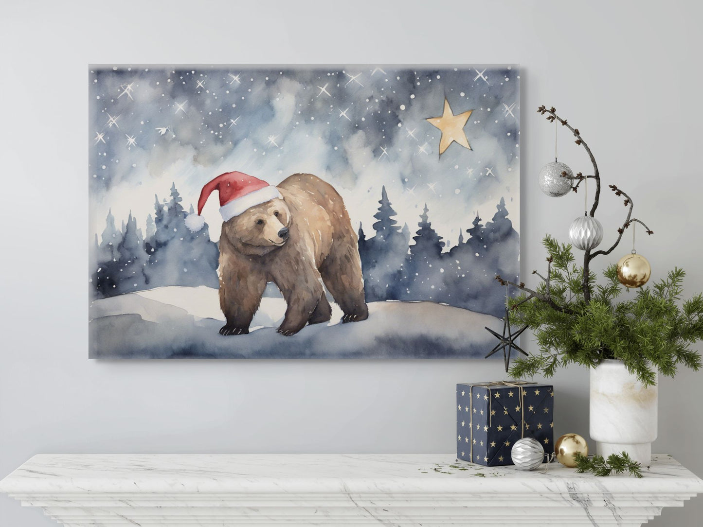 Framed artwork of a bear wearing a Santa hat in a snowy landscape, with decorative items on a table below.