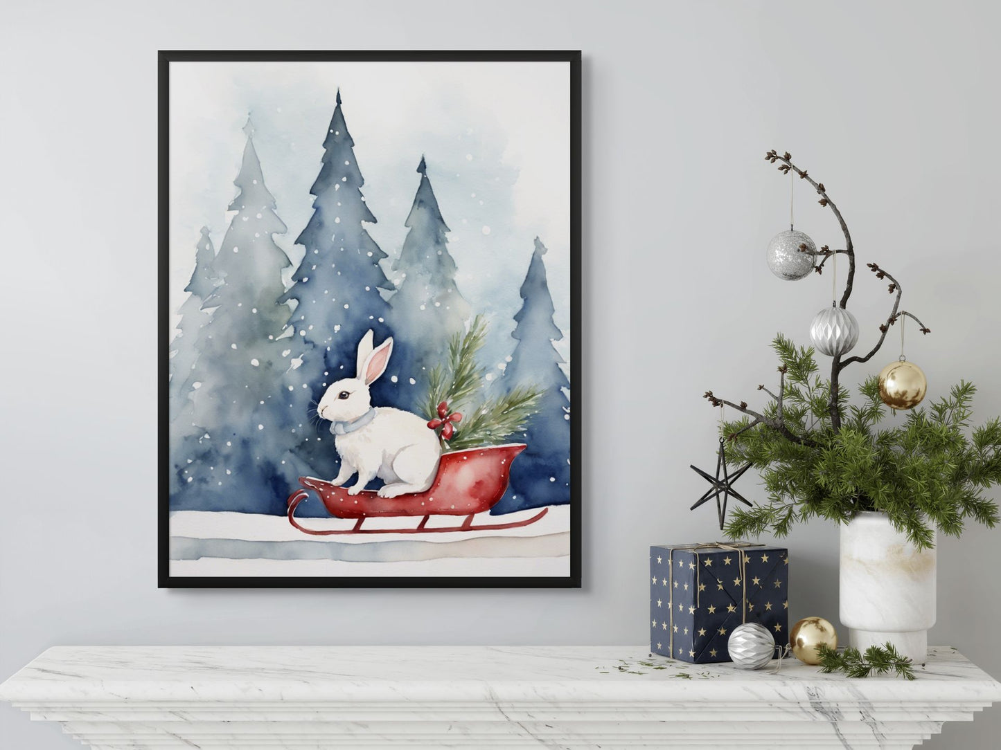 Framed artwork of a rabbit in a sleigh with Christmas decorations on a wall.