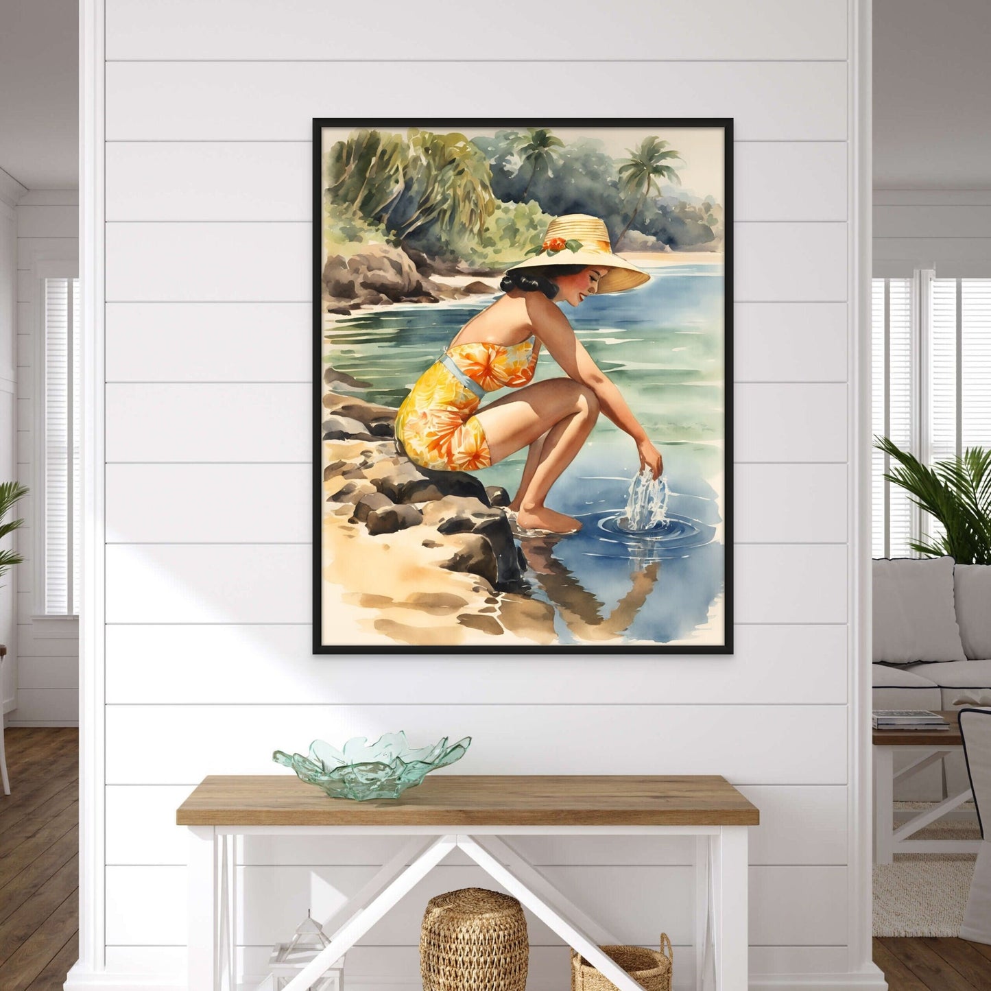 vintage style watercolor painting a woman at a hawaiian beach displayed above an entry table on a white shiplap wall