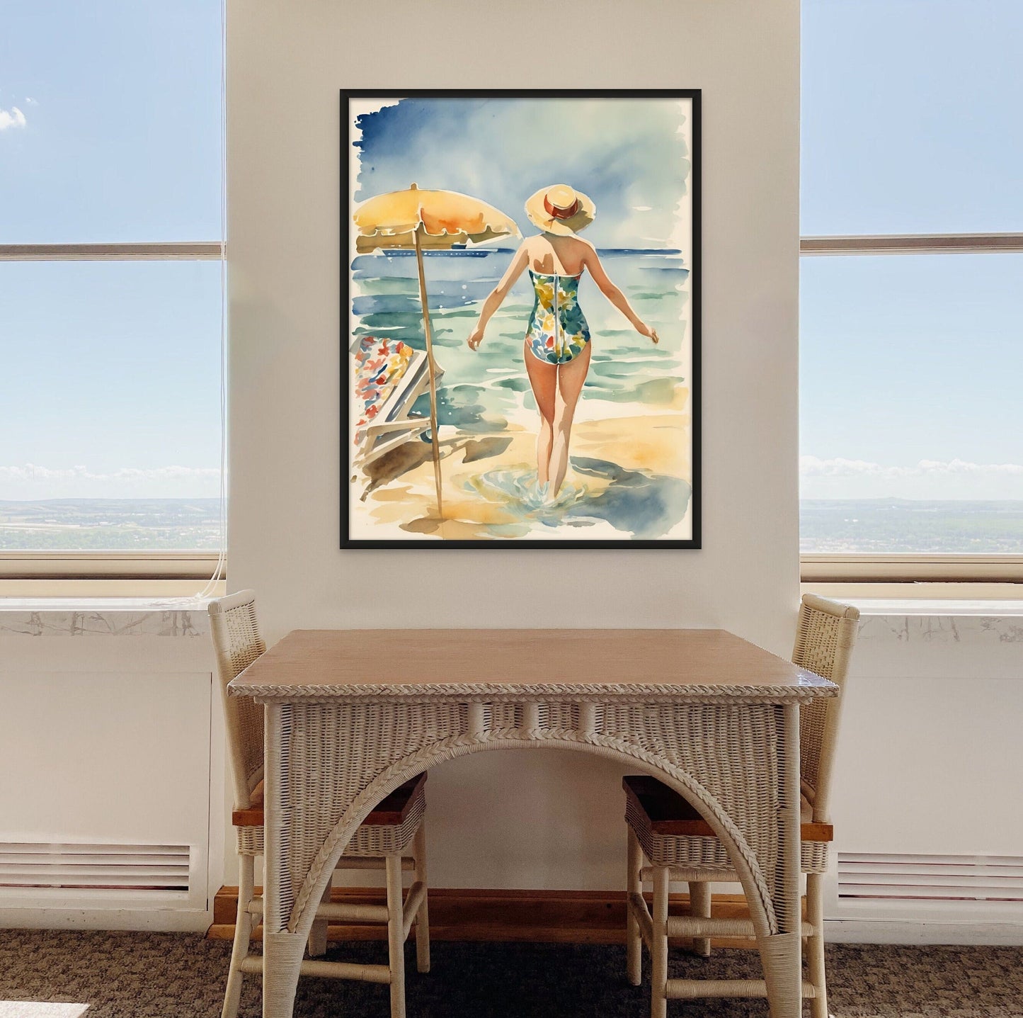 vintage style watercolor painting a woman at a beach displayed above a two seater table with a beach view