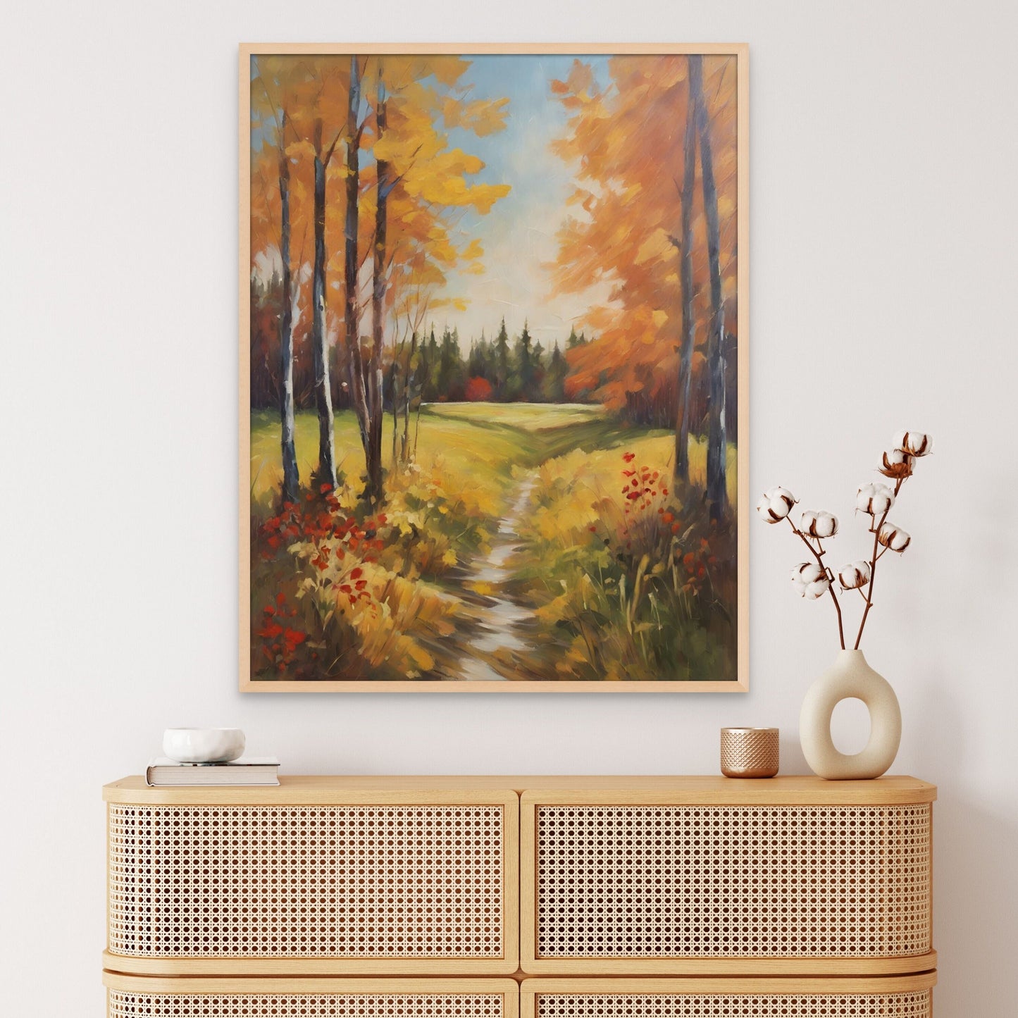 Follow the path through the woods in autumn art displayed above a light color minimalist buffet