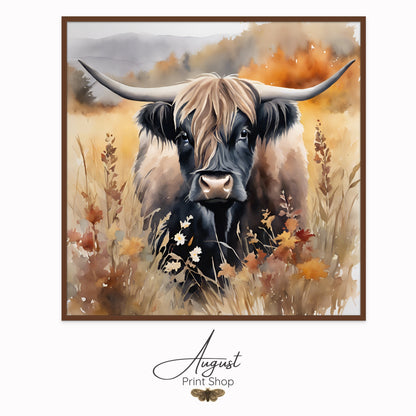 Wall art of a shaggy black highland cow standing in a field surrounded by fall colors