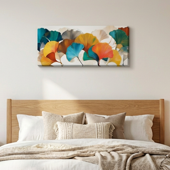 a colourful artwork of ginkgo leaves displayed over a bed 