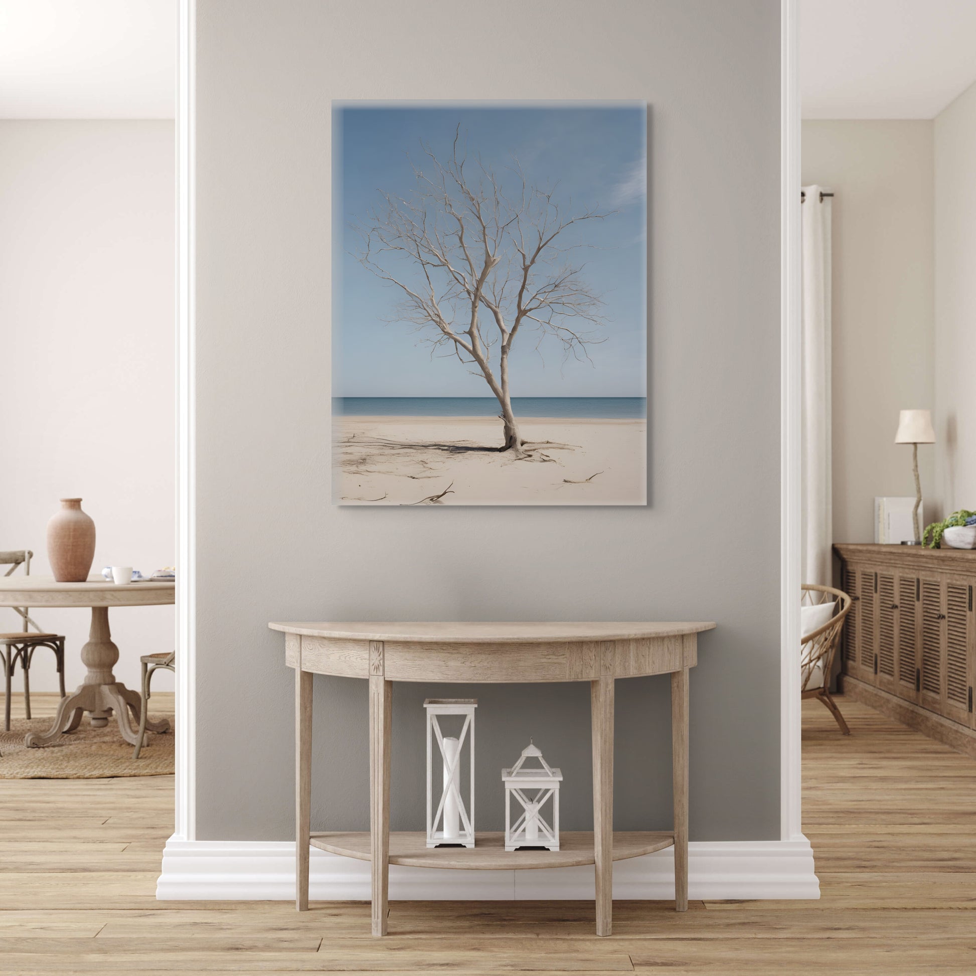 photograph print on canvas of leafless tree in the middle of a sunny, calm beach.