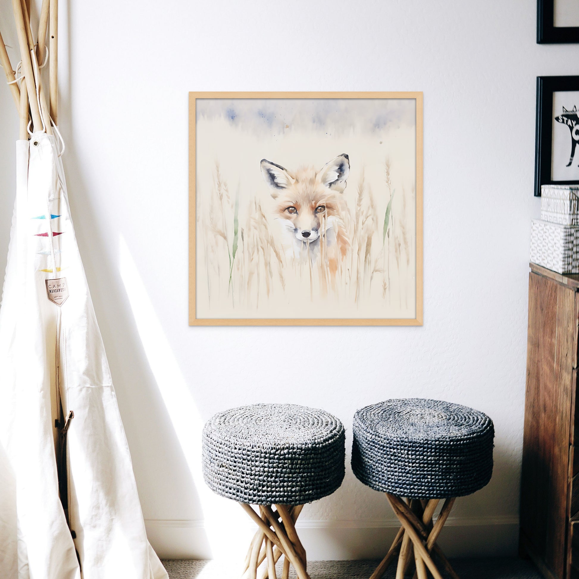 A soft and adorable watercolour painting style print on canvas of a red fox kit hiding in the tall, pale grass. displayed in a childs room
