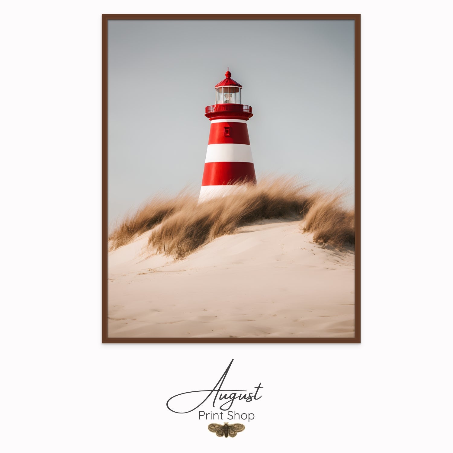 a red and white lighthouse from a view in the sand dunes. Featuring wind blown beach grass and a bright sunny day.