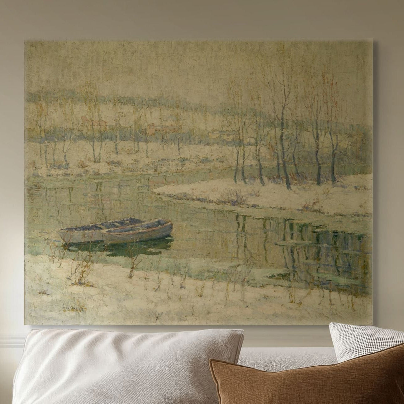 Sofa with decorative pillows and a painting of a landscape with a boat on the wall.
