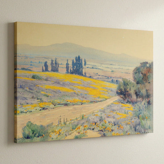 Canvas print of a landscape painting with fields and trees on a wall.