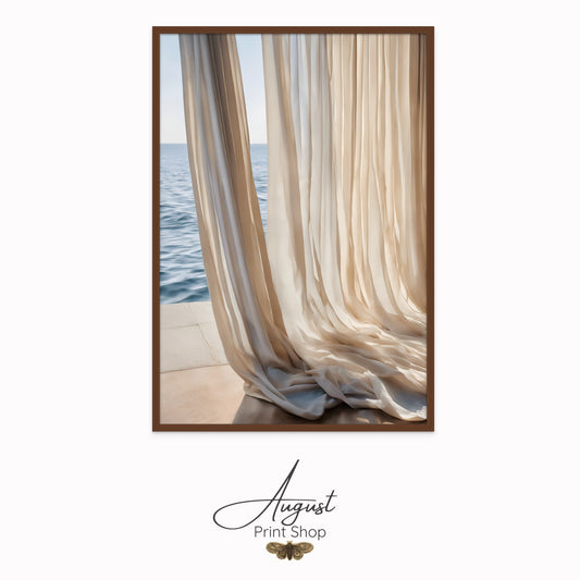 Light and sheer linen beige curtains flow on the floor next to a window that over looks the ocean