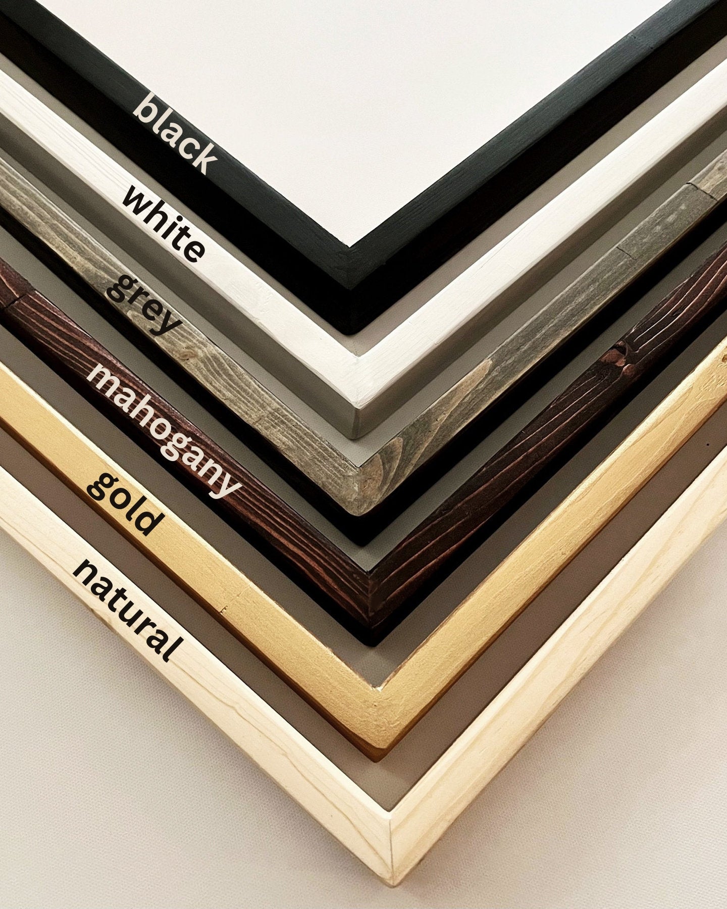 custom frame options done on solid wood include the colors black, white, grey, mahogany, gold and natural