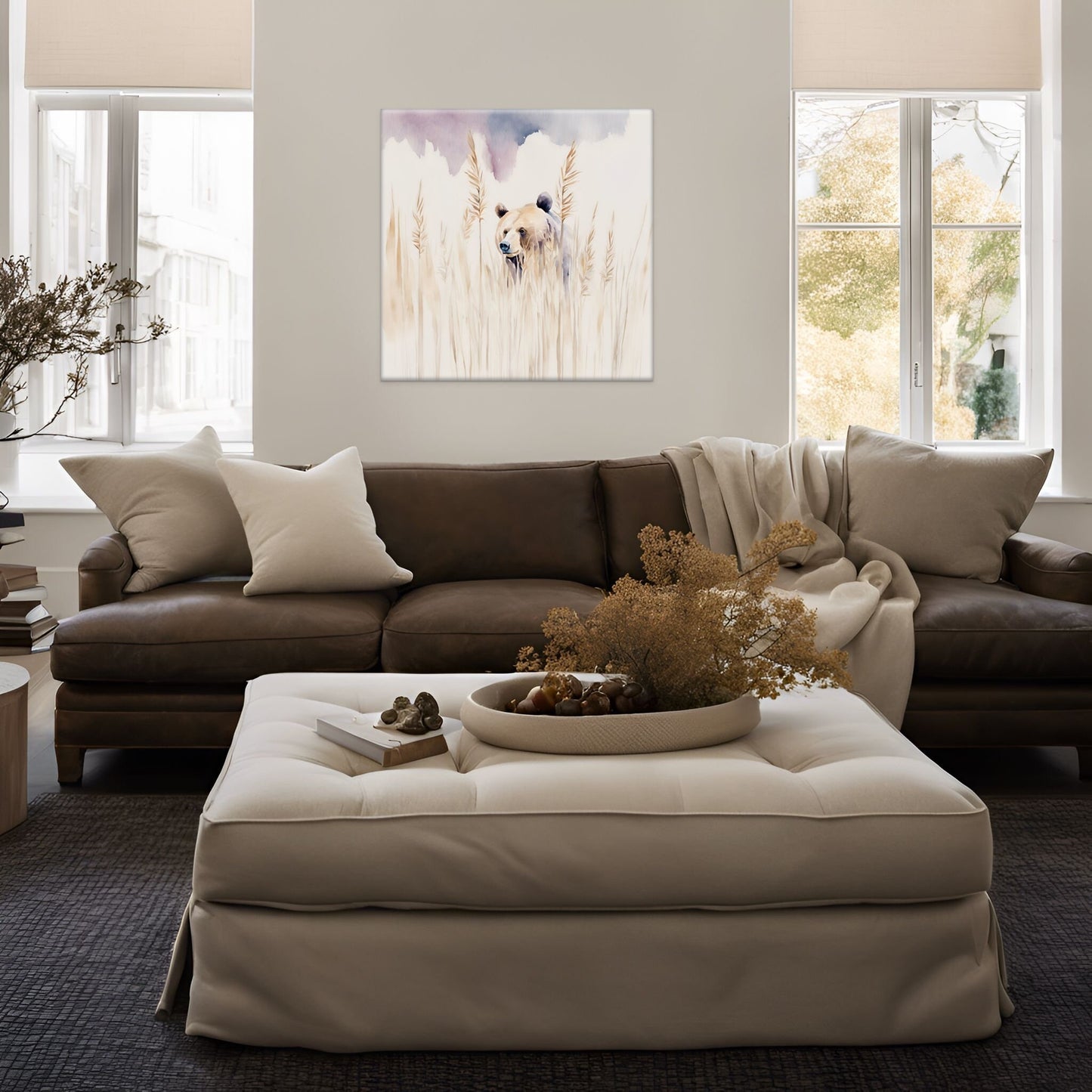 Wall art watercolor of a brown bear peeking out of a field. artwork displayed above a dark brown leather couch and white ottoman