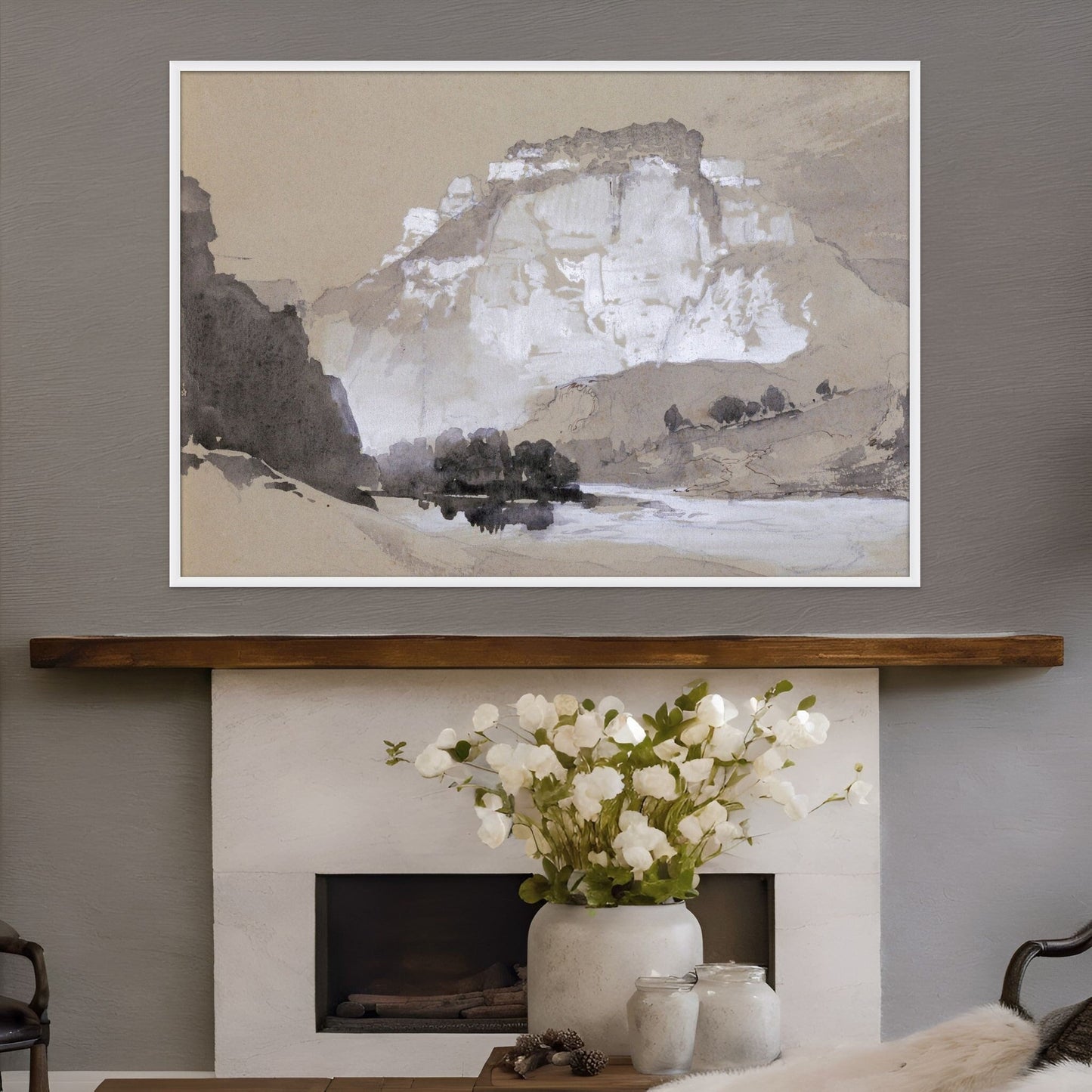 Belle Canon artwork shown above a white stone fireplace and white flowers on a tabble